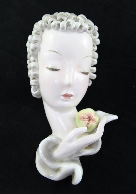 A Goldscheider mask of a lady holding a fruit, 8in.